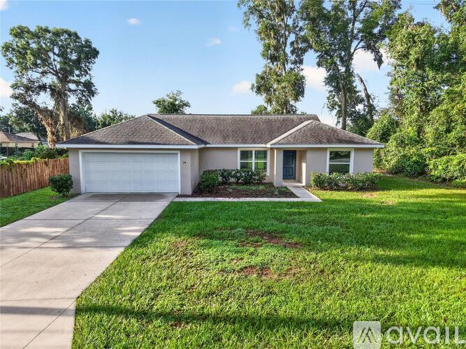 A house with a brown roof and a white garage door.