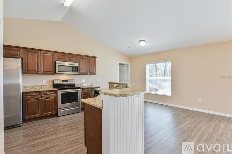 A kitchen with wooden cabinets and a white refrigerator.