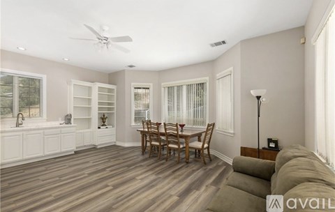 A living room with a dining table and chairs.