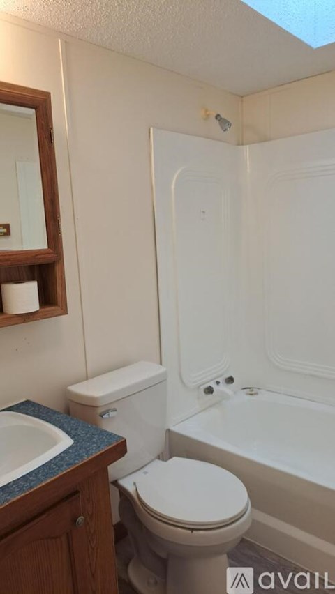 A bathroom with a toilet, sink, and bathtub.