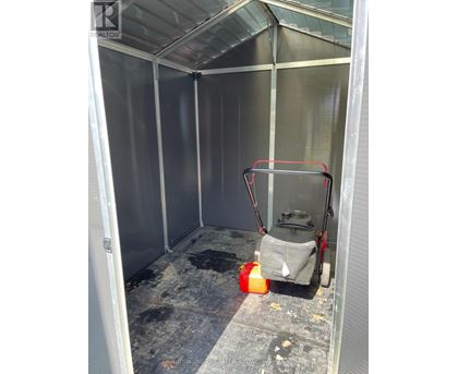A cleaning machine is inside a room with a grey floor.