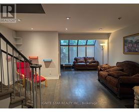 A living room with a brown couch and a red chair.