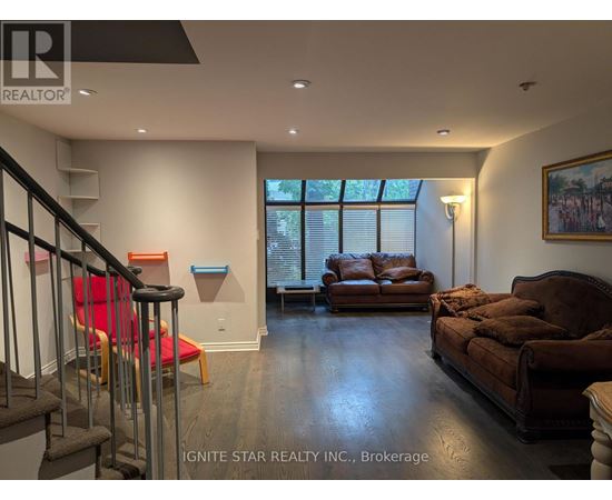 A living room with a brown couch and a red chair.