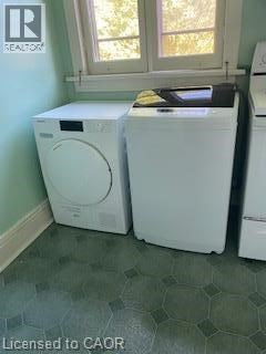 Two white front load washing machines in a laundry room.