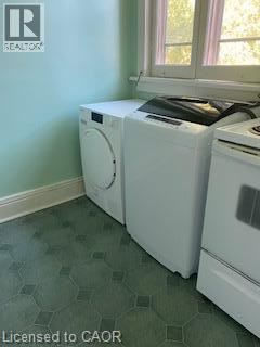 A white dryer and washing machine in a laundry room.