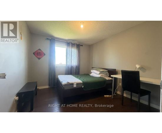 A bedroom with a bed, desk, and chair is for rent.