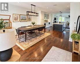 A well-lit, spacious dining room with a large table and chairs.