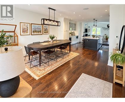 A well-lit, spacious dining room with a large table and chairs.