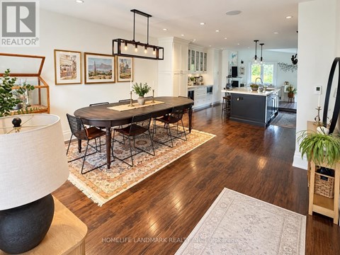 A well-lit, spacious dining room with a large table and chairs.