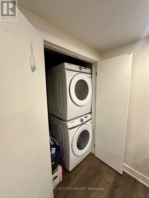 A laundry room with a stack of washing machines.