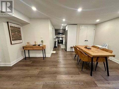 A dining room with a wooden table and chairs.