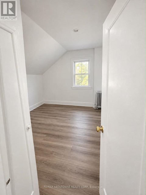 A room with a wooden floor and a window.