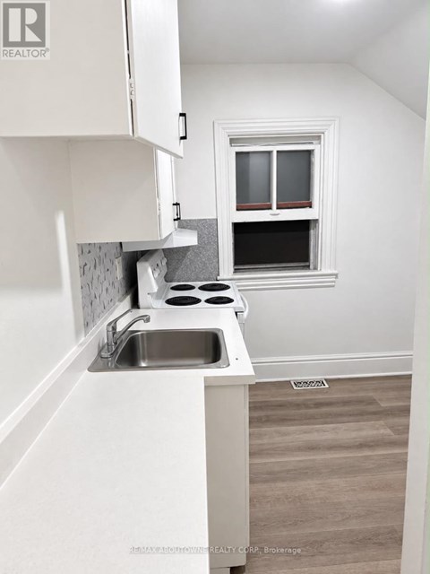 A small kitchen with a sink and a window.