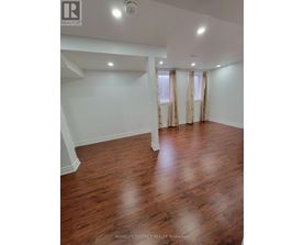 A room with wooden floors and white walls.