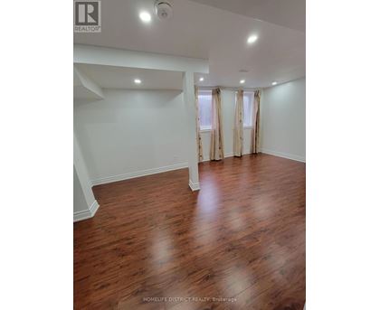A room with wooden floors and white walls.