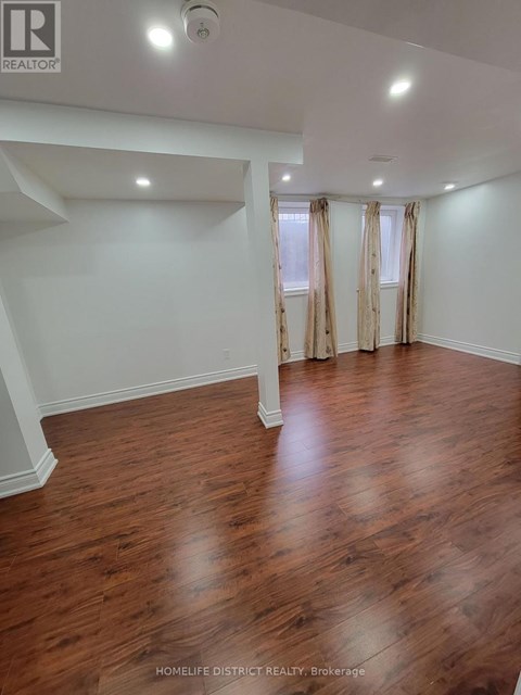 A room with wooden floors and white walls.