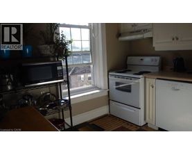 A kitchen with a microwave, oven, and stove.