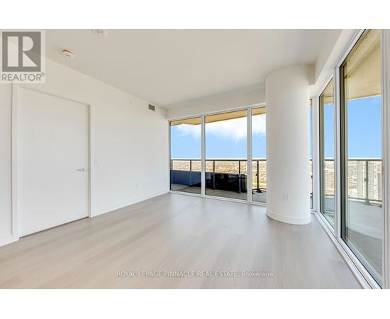A spacious room with a view of the beach through large windows.