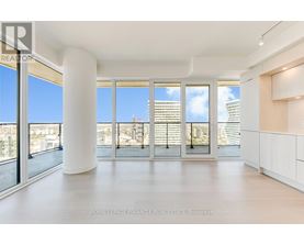 A spacious, well-lit room with large windows and a view of the cityscape.