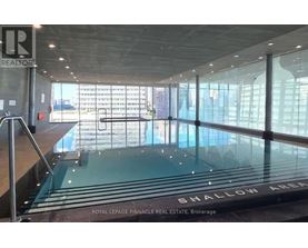A large glass wall with a pool in the middle of it.