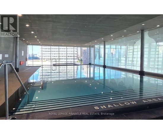 A large glass wall with a pool in the middle of it.