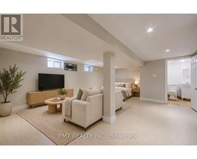 A living room with a flat screen TV and a large couch.