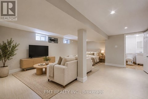 A living room with a flat screen TV and a large couch.