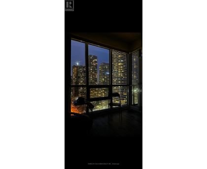 A room with a view of the city at night.