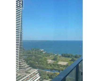 A view from a high-rise building overlooking a coastal landscape.