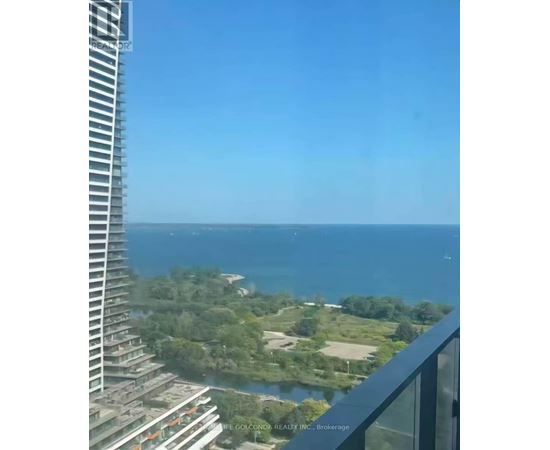 A view from a high-rise building overlooking a coastal landscape.