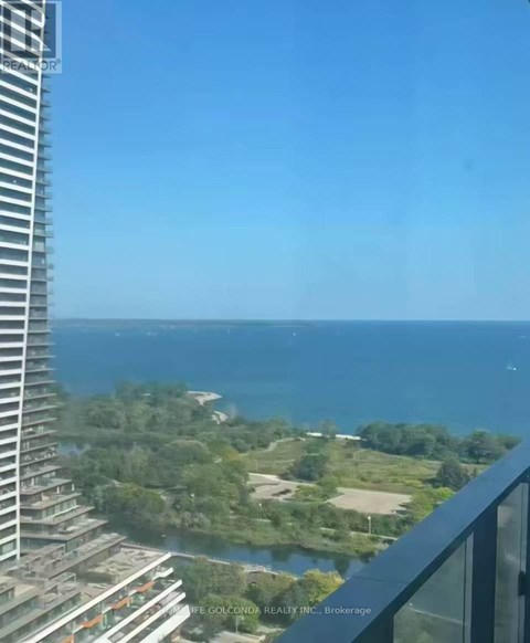 A view from a high-rise building overlooking a coastal landscape.
