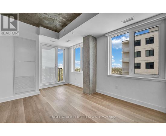 A room with a view of a building outside the window.