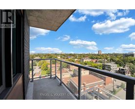 A balcony with a view of a cityscape and buildings.