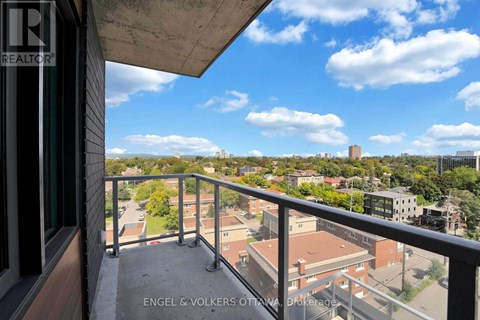 A balcony with a view of a cityscape and buildings.