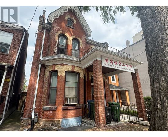 A red brick building with a sign that reads "Bosley Real Estate".