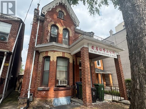 A red brick building with a sign that reads "Bosley Real Estate".