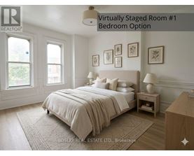 A bedroom with a large bed and a nightstand.