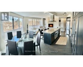 A modern kitchen with a dining table and chairs.