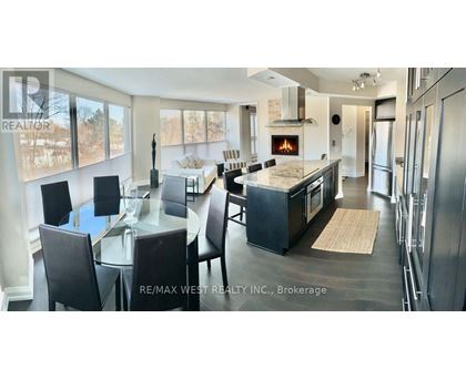 A modern kitchen with a dining table and chairs.