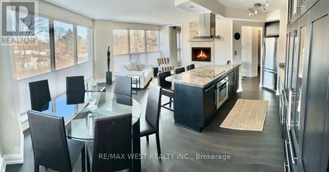A modern kitchen with a dining table and chairs.