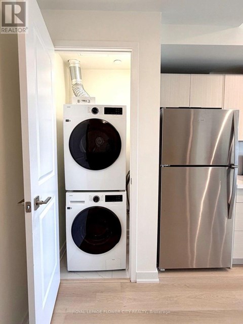 A white washer and dryer are in a small laundry room.