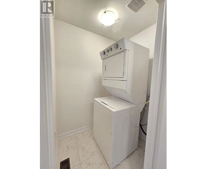 A white oven and dishwasher in a small kitchen.