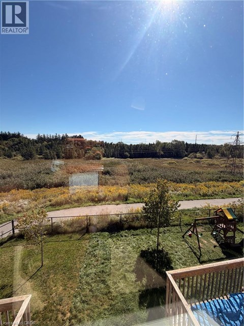 A sunny day in a backyard with a pool and a swing set.