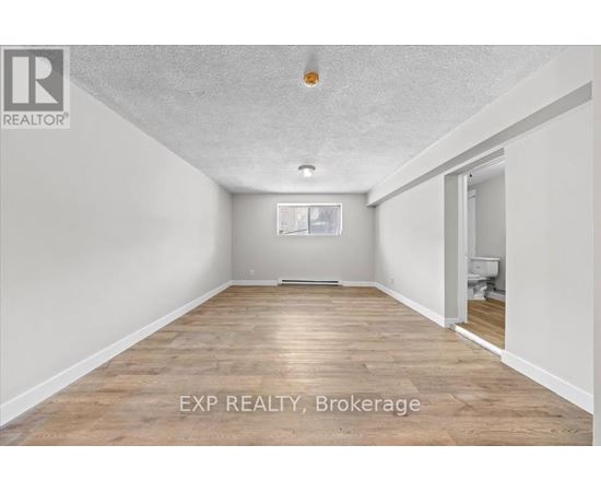 A room with EXP Realty Brokerage written on the floor.
