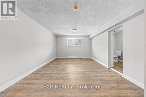 A room with EXP Realty Brokerage written on the floor.
