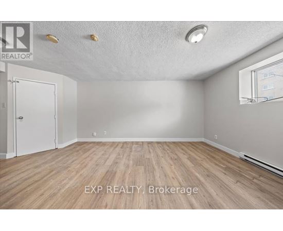 A room with EXP Realty Brokerage logo on the floor.