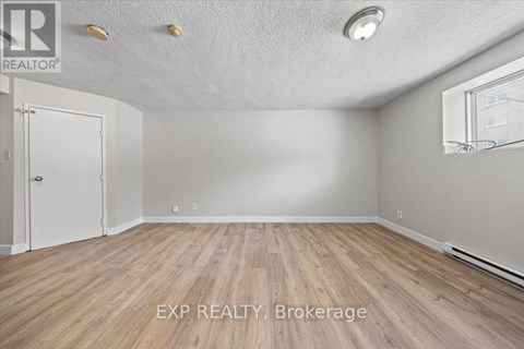 A room with EXP Realty Brokerage logo on the floor.
