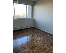 A room with a window and a radiator on the floor.