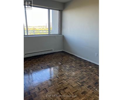 A room with a window and a radiator on the floor.