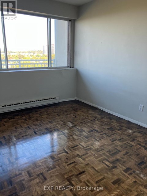 A room with a window and a radiator on the floor.